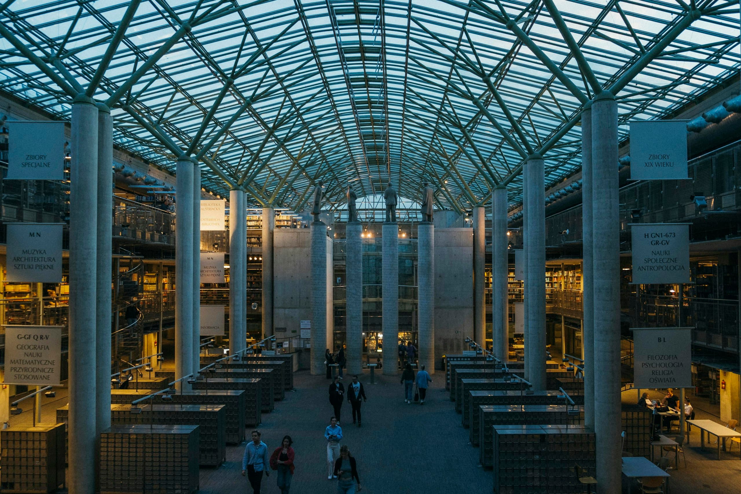 Glass-roofed university atrium at dusk